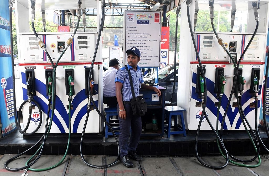 An Indian petrol pump attendant waits for customers at a gas station in Kolkata on June 16, 2017. (DIBYANGSHU SARKAR/AFP/Getty Images)
