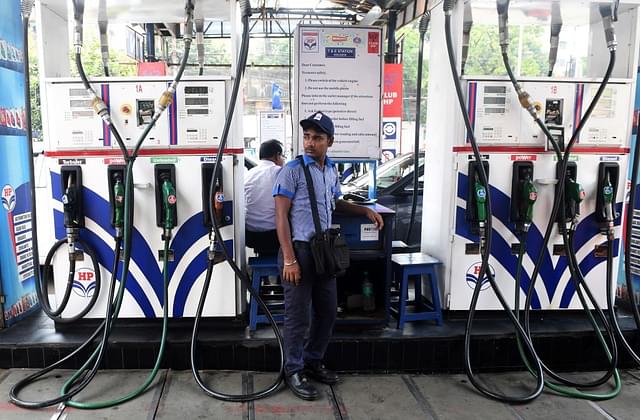 A petrol pump attendant waits for customers at a gas station in Kolkata. (DIBYANGSHU SARKAR/AFP/Getty Images)