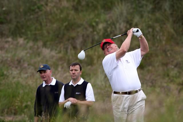 
President Donald Trump playing golf.<br>