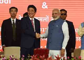 Prime Minister Narendra Modi and Japan’s Prime Minister Shinzo Abe shake hands during a ground-breaking ceremony for the Mumbai-Ahmedabad high speed rail project in Ahmedabad on 14 September 2017.  (SAM PANTHAKY/AFP/GettyImages)