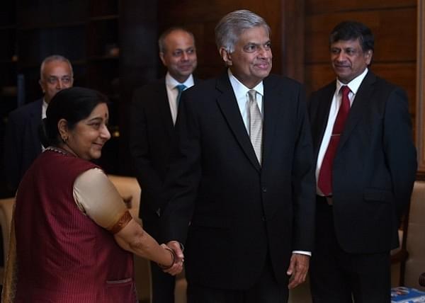 Sri Lanka’s Prime Minister Ranil Wickremesinghe shakes hands with Foreign Minister Sushma Swaraj (L) during the opening of the two-day Indian Ocean Conference 2017 in Colombo. (ISHARA S. KODIKARA/AFP/Getty Images)