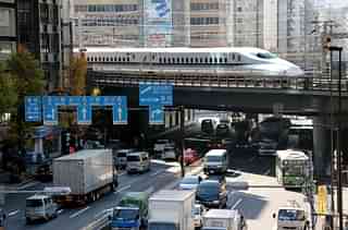 A Shinkansen train over a road in Tokyo (YOSHIKAZU TSUNO/AFP/GettyImages)
