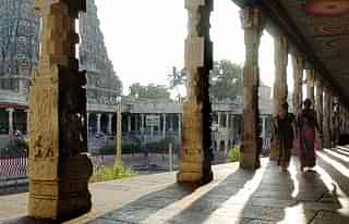 Devotees walk through a collonade at the Meenakshi Temple in Madurai (DIBYANGSHU SARKAR/AFP/Getty Images)