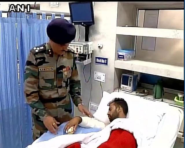 A doctor attends to an injured soldier.