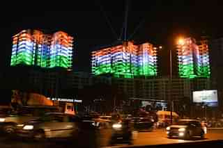 A row of apartment buildings is illuminated with the colours of the Indian national flag on the eve of Republic Day celebrations in Bangalore on January 25, 2016 (MANJUNATH KIRAN/AFP/Getty Images)