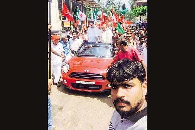 CPM’s Kodiyeri Balakrishnan riding the Mini Cooper during a rally. (Facebook)