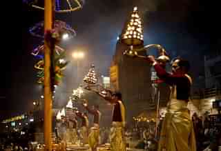Hindu priests offer evening prayers on the banks of the River Ganges in Varanasi. (MANAN VATSYAYANA/AFP/Getty Images)