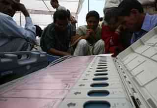 ECI Officials checking EVMs before deploying them (Vikas Khot./Hindustan Times via Getty Images)