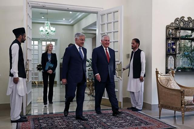 Rex Tillerson (second right) walks with  Khawaja Asif as he arrives at the Prime Minister’s residence in Islamabad on 24 October 2017. (ALEX BRANDON/AFP/GettyImages)