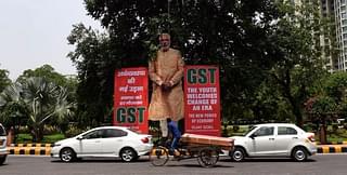 Indian motorists drive past a billboard displaying an image of Prime Minister Narendra Modi and announcing the implementation of the GST in New Delhi. (PRAKASH SINGH/AFP/Getty Images)
