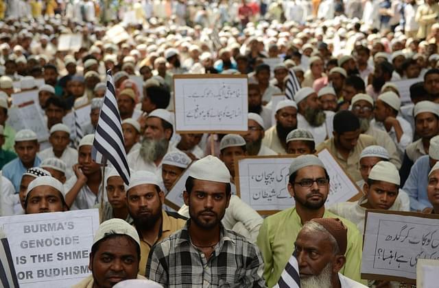 Indian Muslim activists hold placards as they shout slogans during a protest against the government of Myanmar over the treatment of Rohingya Muslims (MONEY SHARMA/AFP/Getty Images)