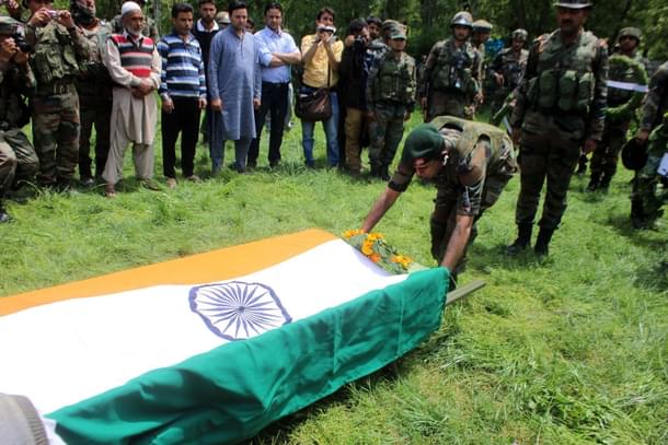 Army soldiers pay tribute to their colleague Lieutenant Umar Fayaz Parray during his funeral procession at Sudsun Yaripora village, in Kulgam. (Waseem Andrabi/Hindustan Times via Getty Images) 