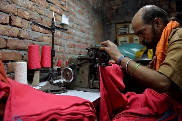 An Indian man works on a machine at a garment factory in Ludhiana. (MONEY SHARMA/AFP/Getty Images)