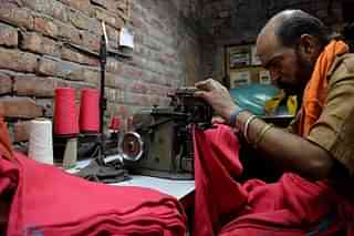 An Indian man works on a machine at a garment factory in Ludhiana. (MONEY SHARMA/AFP/Getty Images)