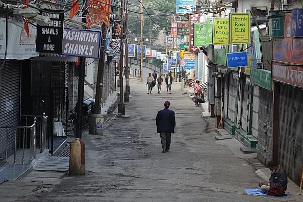 Residents walk in the deserted market area during a general strike called by the GJM in Darjeeling. (DIPTENDU DUTTA/AFP/GettyImages)