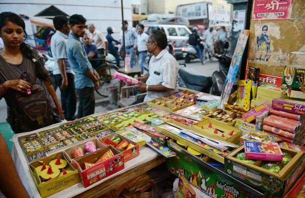 A woman looks at firecrackers on display at a shop in New Delhi. (MONEY SHARMA/AFP/Getty Images) 