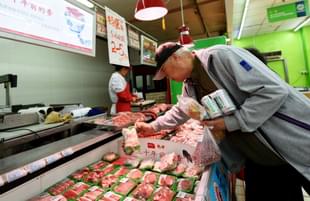 Customers select pork at a supermarket in Hangzhou, east China’s Zhejiang province on April 12, 2017. (STR/AFP/Getty Images)