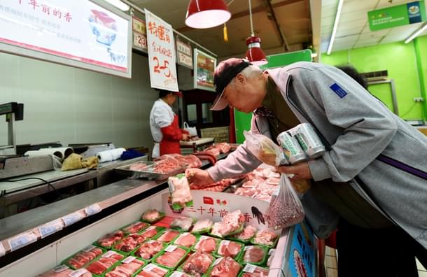 Customers select pork at a supermarket in Hangzhou, east China’s Zhejiang province on April 12, 2017. (STR/AFP/Getty Images)