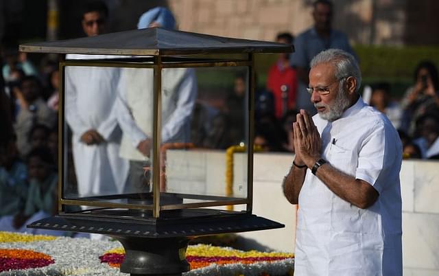 Prime Minister Narendra Modi pays tribute to Mahatma Gandhi on his 148th birth anniversary at Rajghat in New Delhi on 2 October. (PRAKASH SINGH/AFP/Getty Images)