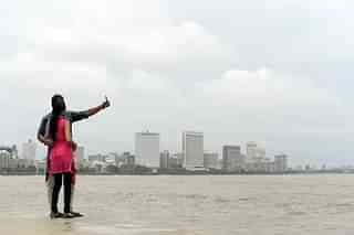 A young Indian couple take a ‘selfie’ on Marine Drive promenade in Mumbai. (INDRANIL MUKHERJEE/AFP/Getty Images)