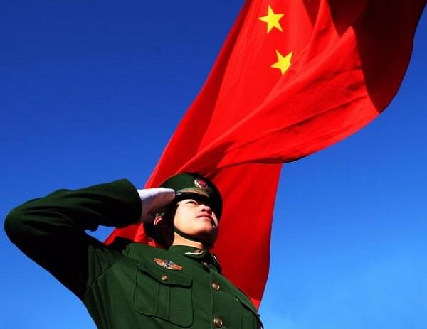  Paramilitary policeman does a national flag rising ceremony to mark the New Year before thousands of people climb the Great Wall on January 1, 2009 in Beijing, China. (Guang Niu/Getty Images)