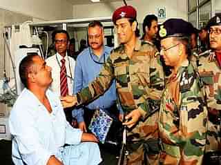 Former Indian cricket team captain Mahendra Singh Dhoni visits an injured soldier.