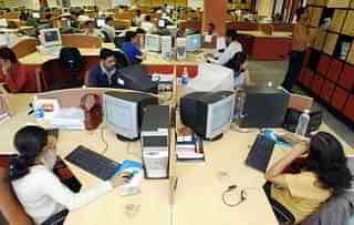 Software Professionals of Indian software firm Ivega Corp work at their workstations at the company’s office in Global Village in India’s technology hub on the outskirts of Bangalore 20 June 2003. (INDRANIL MUKHERJEE/AFP/Getty Images)