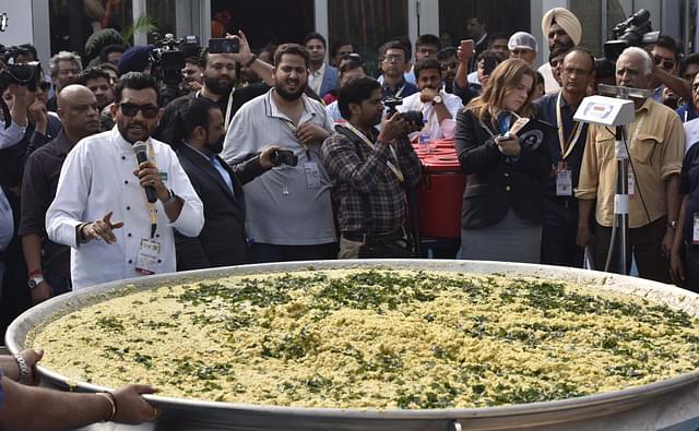 A team of nearly two dozen people cooked khichdi on 4 November in New Delhi in an attempt to enter Guinness World Records at World Food India fair. (Sonu Mehta/Hindustan Times via GettyImages)