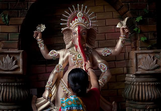 A Bangladeshi Hindu devotee worships Lord Ganesh in Dhaka, Bangladesh. (Allison Joyce/GettyImages)