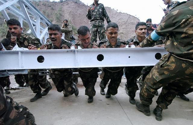 Indian army soldiers work to rebuild a bridge (Sajjad Hussain/AFP/Getty Images)