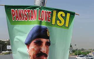 A banner bearing the image of the country’s ISI Chief Lt General Zaheer Islam. (AAMIR QURESHI/AFP/Getty Images)