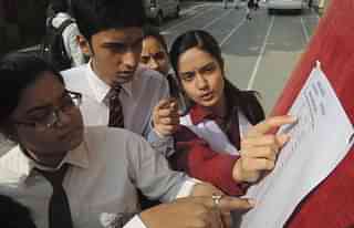 Students check their roll numbers at an examination centre. (Deepak Gupta/Hindustan Times via Getty Images)