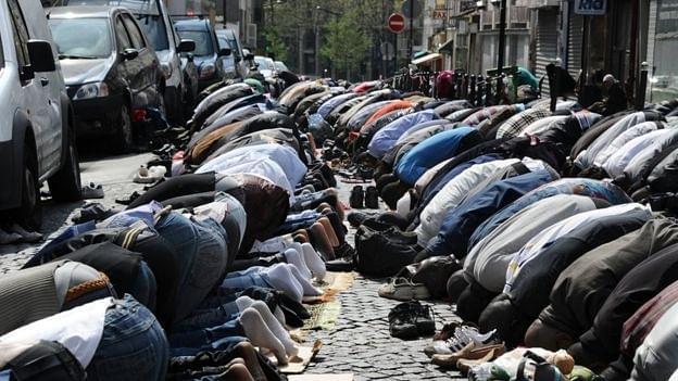 Muslims pray in the street as part of Friday’s prayers on 8 April 2011 in Paris