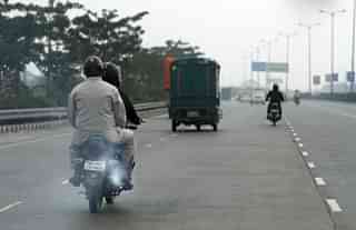 A motorcycle emitting smoke in Delhi (Arun Sharma/ Hindustan Times via Getty Images)