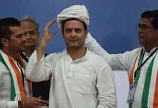 Congress workers present a turban to Rahul Gandhi during a public meeting at Varachha Surat, on 3 November in Gujarat, India. (Vijayanand Gupta/Hindustan Times via GettyImages)