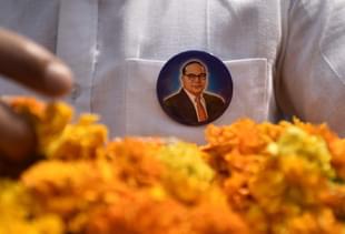 People buy posters and souvenirs to pay tribute to Dr Bhim Rao Ambedkar on his 126 birth anniversary at Parliament Street in New Delhi.  (Sushil Kumar/Hindustan Times via Getty Images)