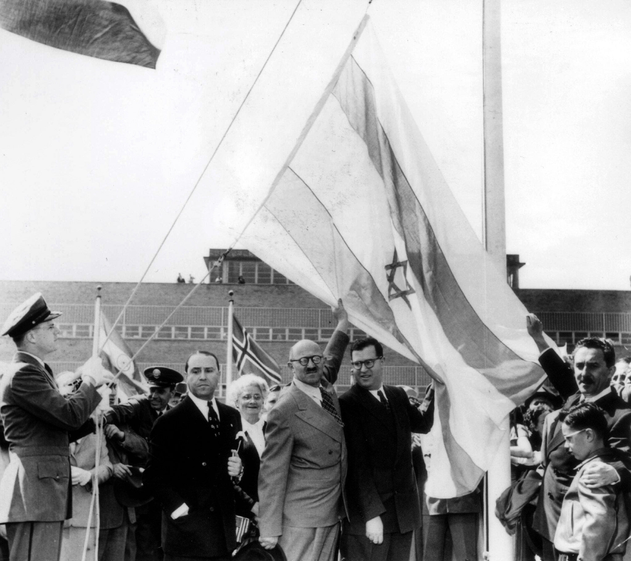  Moshe Sharett (C), Abba Eban (2nd R) and David Hacohen (R), raise what would become the Israeli flag after the United Nations decided to approve the partition of Palestine November 29, 1947 in New York. (Photo by GPO via Getty Images)