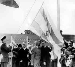  Moshe Sharett (C), Abba Eban (2nd R) and David Hacohen (R), raise what would become the Israeli flag after the United Nations decided to approve the partition of Palestine November 29, 1947 in New York. (Photo by GPO via Getty Images)