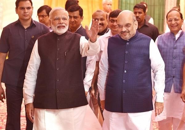 Prime Minister Narendra Modi and BJP president Amit Shah arrive to attend the Diwali Mangal Milan with journalists at BJP headquarters in New Delhi. (Raj K Raj/Hindustan Times via Getty Images)