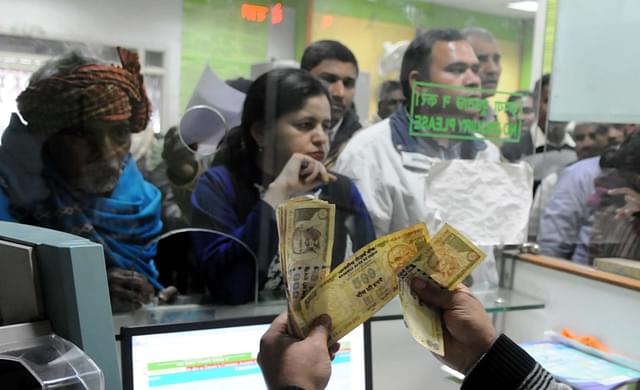 A banker counting old banknotes during demonetisation (Parveen Kumar/Hindustan Times via Getty Images)