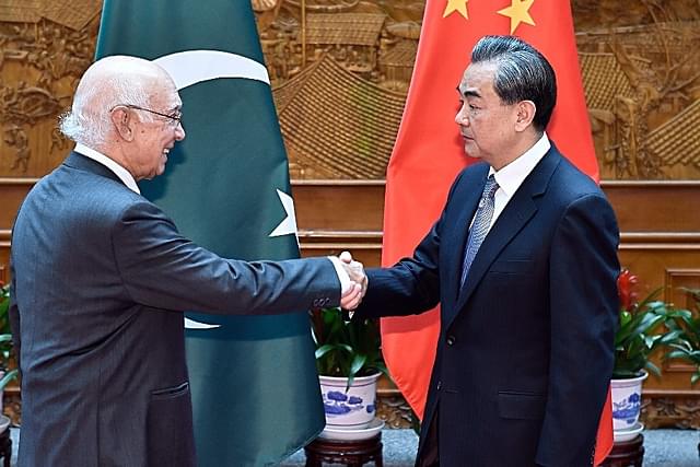 Pakistan Foreign Affairs Adviser Sartaj Aziz shakes hands with Chinese Foreign Minister Wang Yi. (Photo by Iori Sagisawa-Pool/Getty Images)
