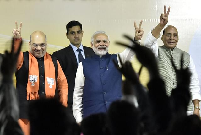 Prime Minister Narender Modi, BJP national president Amit Shah and Home Minister Rajnath Singh greet BJP workers after winning Gujarat and Himachal Pradesh elections at the party headquarters in New Delhi. (Sonu Mehta/Hindustan Times via GettyImages)