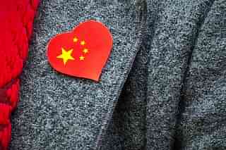A pro-China supporter wears a sticker with the country’s flag on, during a counter protest held near Amnesty International, protesting against claims of a deterioration in human rights and censorship of the internet and media during a state visit by Chinese President Xi Jinping to London. (Ben Pruchnie/GettyImages)