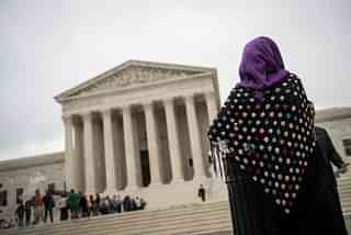 A woman wearing a hijab stands outside the U.S. Supreme Court. (Drew Angerer/Getty Images)
