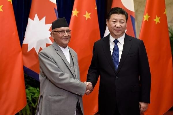 Chinese President Xi Jinping, right, shakes hands with K P Sharma Oli inside the Great Hall of the People in Beijing. (Etienne Oliveau/Getty Images)