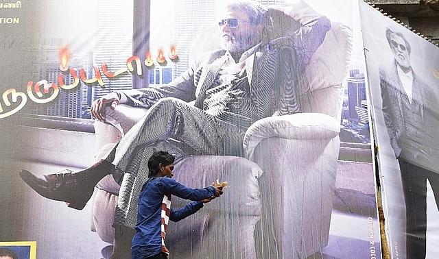 A Rajinikanth fan performs aarti in front of his movie hoarding in Mumbai. (Arijit Sen/Hindustan Times via GettyImages)&nbsp;