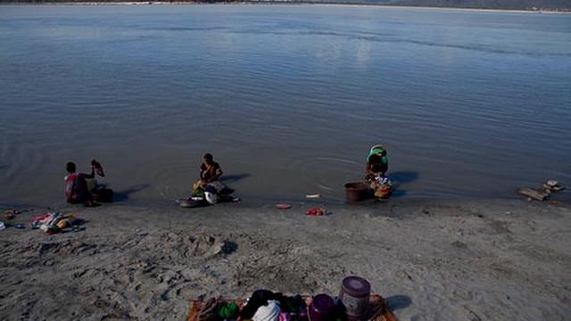 Women wash clothes in the contaminated Brahmaputra water (PTI)