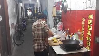 Ayi preparing dinner in the “open-air kitchen”.