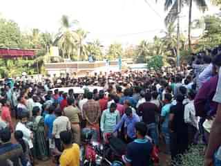 Protesters gather outside the house of Deepak Rao as police move his body to his house.&nbsp;