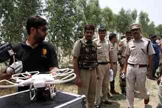 Police officers use a drone to monitor sensitive areas in Rohtak, Haryana (Manoj Dhaka/Hindustan Times via Getty Images)